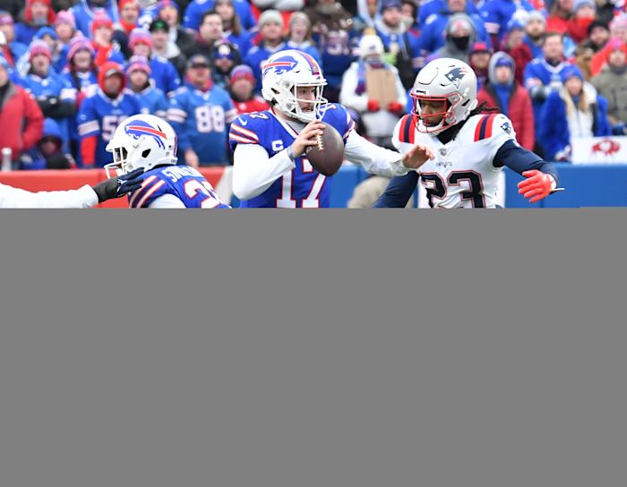 Jan 8, 2023; Orchard Park, New York, USA; Buffalo Bills quarterback Josh Allen (17) is pressured by New England Patriots safety Kyle Dugger (23) in the first quarter at Highmark Stadium.